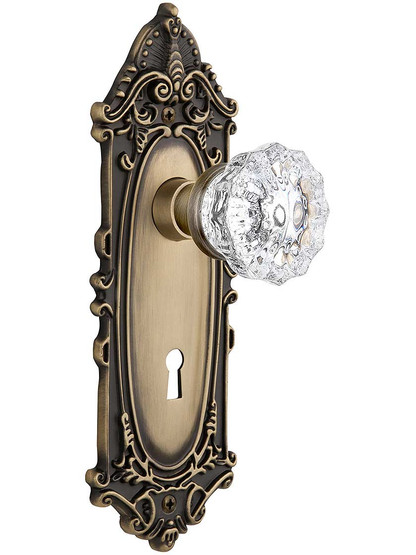 Largo Door Set with Fluted-Crystal Glass Knobs and Keyhole Single Dummy in Antique Brass.